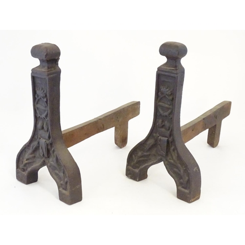 1359 - A pair of 19thC cast iron fire dogs / andirons with foliate and cartouche detail. Approx. 16 1/4