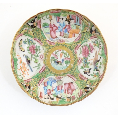 45 - A Chinese / Cantonese plate decorated with figures, birds, butterflies, flowers, and scrolling folia... 