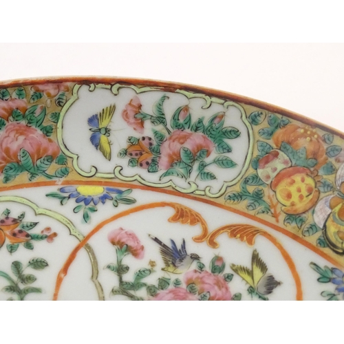 66 - A Chinese / Cantonese famille rose charger decorated with flowers, foliage, birds, butterflies, etc.... 