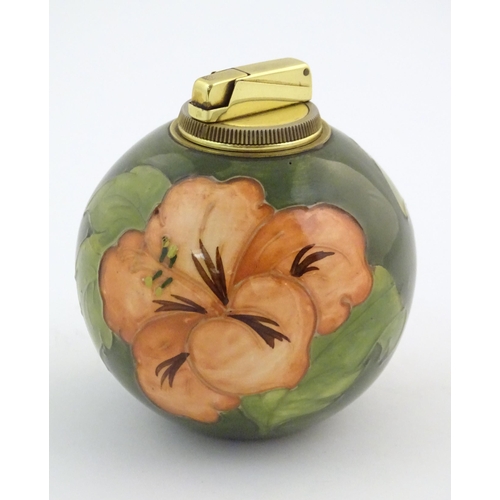 72 - A Moorcroft table lighter of spherical form decorated in the hibiscus flower pattern. Approx. 4 1/2