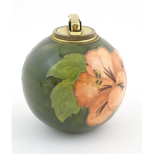 72 - A Moorcroft table lighter of spherical form decorated in the hibiscus flower pattern. Approx. 4 1/2