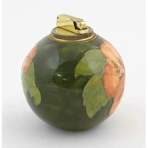 72 - A Moorcroft table lighter of spherical form decorated in the hibiscus flower pattern. Approx. 4 1/2