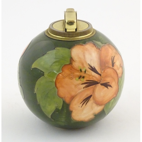 72 - A Moorcroft table lighter of spherical form decorated in the hibiscus flower pattern. Approx. 4 1/2