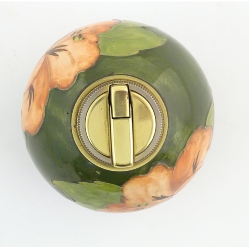 72 - A Moorcroft table lighter of spherical form decorated in the hibiscus flower pattern. Approx. 4 1/2