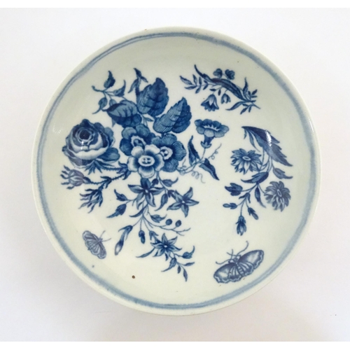 74 - A Worcester blue and white saucer decorated with flowers, foliage and butterflies. Crescent moon mar... 