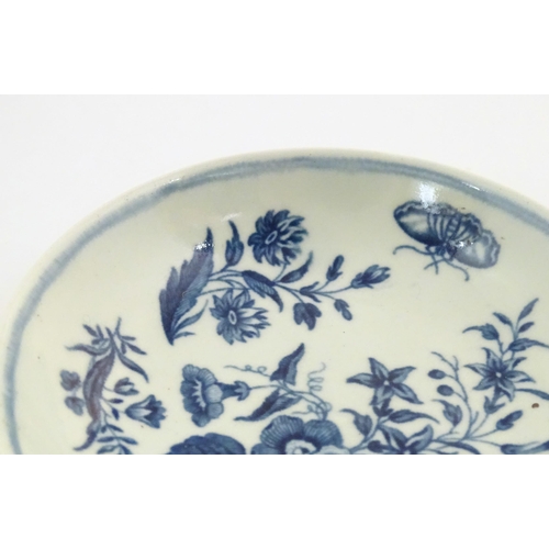 74 - A Worcester blue and white saucer decorated with flowers, foliage and butterflies. Crescent moon mar... 