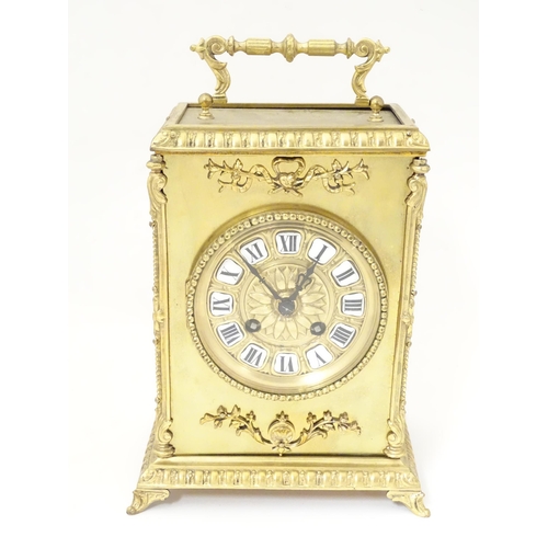 1404 - A late 19thC / early 20thC gilt brass clock with enamel numerals, the 8-day movement striking on a b... 