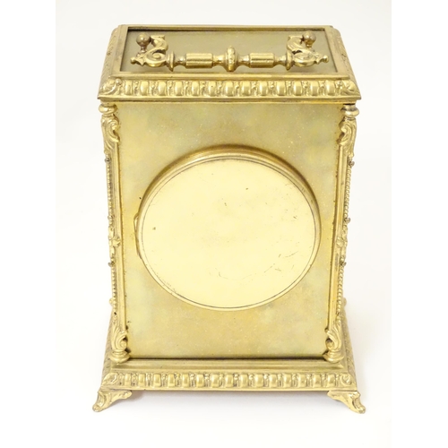 1404 - A late 19thC / early 20thC gilt brass clock with enamel numerals, the 8-day movement striking on a b... 