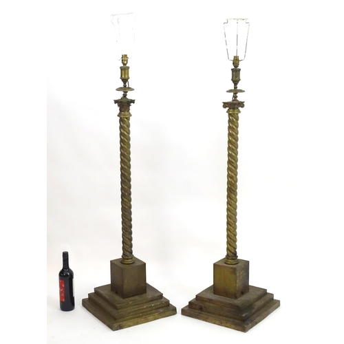 1351 - A pair of brass standard lamps formed as corinthian columns, with twist columns supported by stepped... 