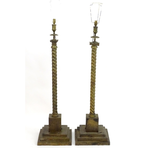 1351 - A pair of brass standard lamps formed as corinthian columns, with twist columns supported by stepped... 