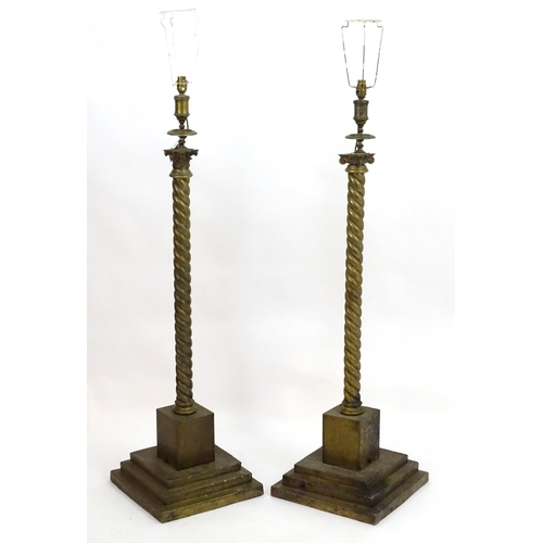 1351 - A pair of brass standard lamps formed as corinthian columns, with twist columns supported by stepped... 