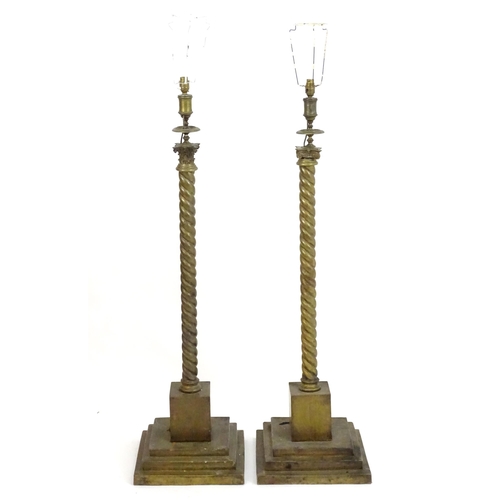 1351 - A pair of brass standard lamps formed as corinthian columns, with twist columns supported by stepped... 