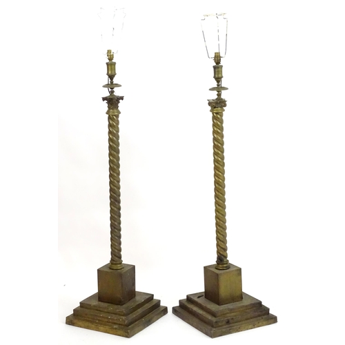 1351 - A pair of brass standard lamps formed as corinthian columns, with twist columns supported by stepped... 