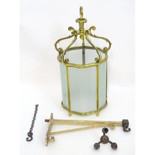 1330 - A 19thC brass hanging lantern and original bracket, the shade with five panels of frosted glass. App... 