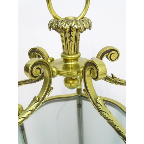 1330 - A 19thC brass hanging lantern and original bracket, the shade with five panels of frosted glass. App... 