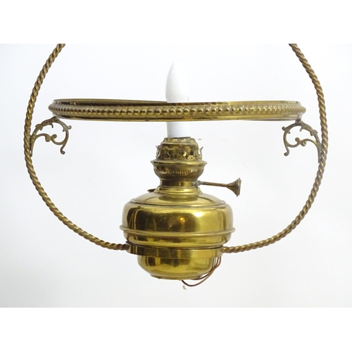 1331 - An early 20thC brass pendant light with white glass shade, the frame decorated with rope twists and ... 