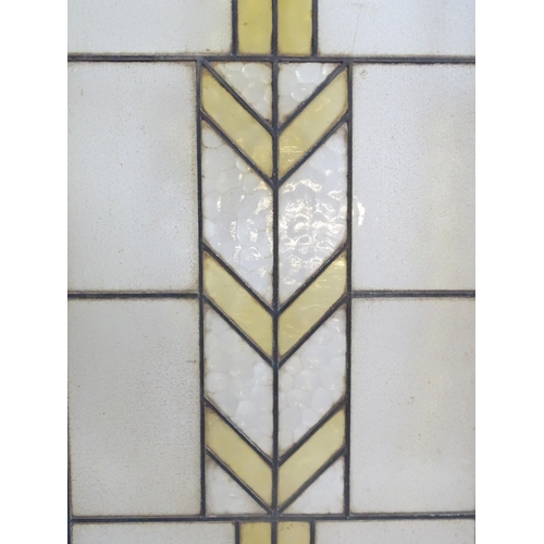 1355 - Two Art Deco stained glass window panes / panels with geometric and chevron detail. Approx. 35