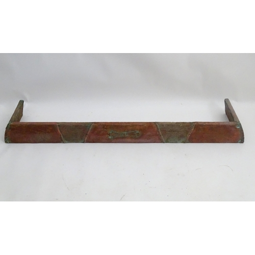 1360 - An early 20thC kerb fender, of copper construction with sectional decoration, approximately 50