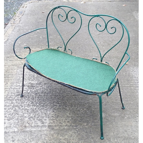 1364 - A two-seater garden bench, of wrought metal construction with two hearts forming the splat, green pa... 