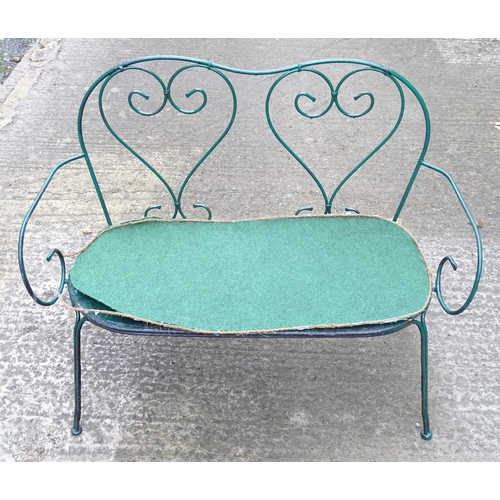 1364 - A two-seater garden bench, of wrought metal construction with two hearts forming the splat, green pa... 