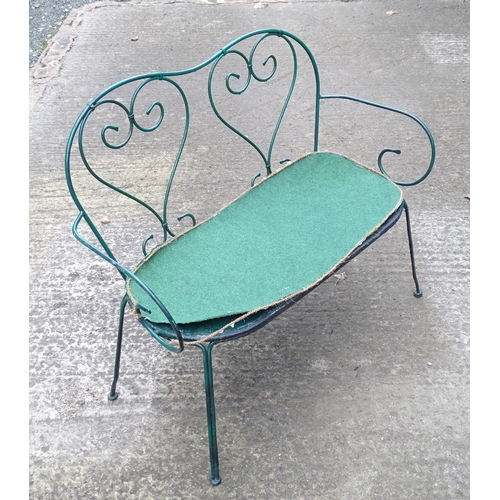 1364 - A two-seater garden bench, of wrought metal construction with two hearts forming the splat, green pa... 