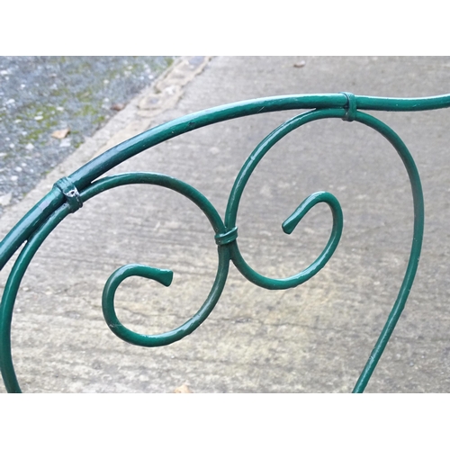 1364 - A two-seater garden bench, of wrought metal construction with two hearts forming the splat, green pa... 