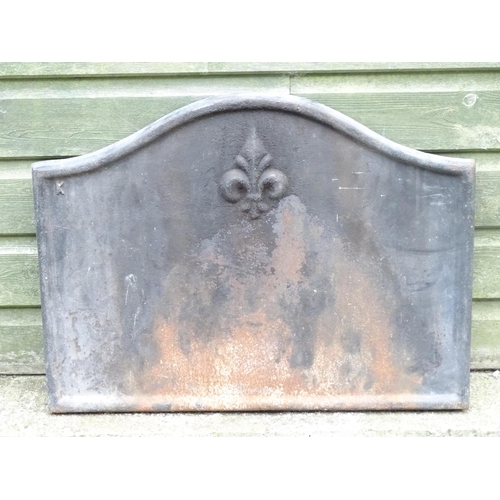 1365 - A mid 20thC cast iron fireback, with raised border and Fleur de Lys decoration, 25 1/2