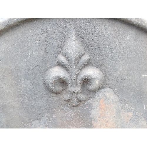 1365 - A mid 20thC cast iron fireback, with raised border and Fleur de Lys decoration, 25 1/2