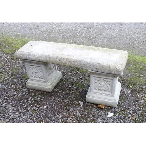 1372 - A late 20thC reconstituted stone garden bench, consisting of two pedestals supporting a rectangular ... 