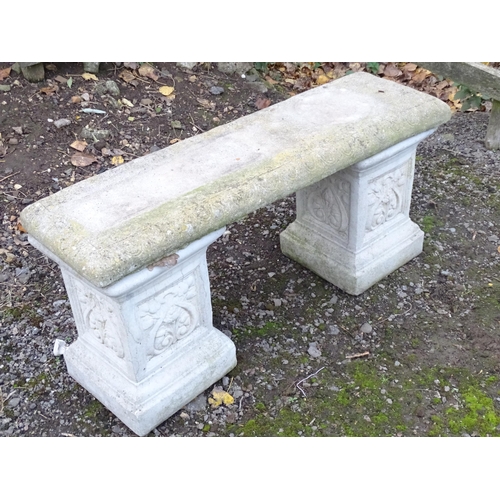 1372 - A late 20thC reconstituted stone garden bench, consisting of two pedestals supporting a rectangular ... 