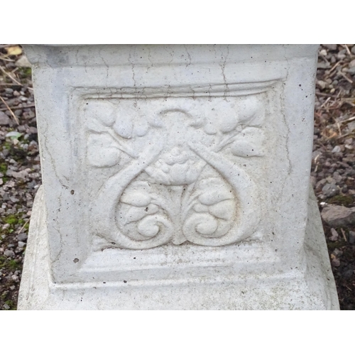 1372 - A late 20thC reconstituted stone garden bench, consisting of two pedestals supporting a rectangular ... 