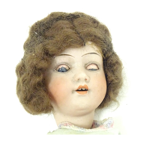 1298 - Toy: an early 20thC bisque doll by Herman Steiner , Bavaria. The head with back stamps: 'Made in Ger... 