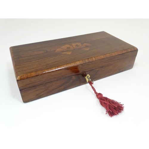 1302 - A 19thC rosewood games box, the lid decorated with playing card suits opening two reveal a fitted in... 