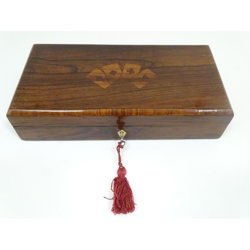 1302 - A 19thC rosewood games box, the lid decorated with playing card suits opening two reveal a fitted in... 