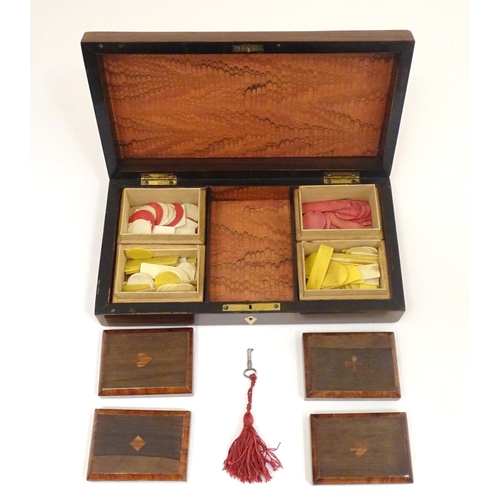 1302 - A 19thC rosewood games box, the lid decorated with playing card suits opening two reveal a fitted in... 