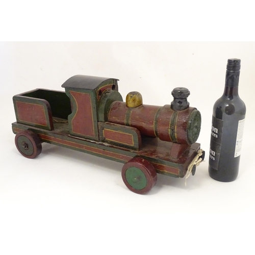 1313 - Toy: an early to mid 20thC hand made and hand painted model pull-along locomotive / train , approxim... 