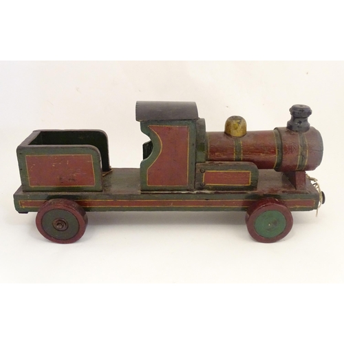 1313 - Toy: an early to mid 20thC hand made and hand painted model pull-along locomotive / train , approxim... 