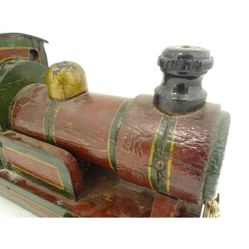 1313 - Toy: an early to mid 20thC hand made and hand painted model pull-along locomotive / train , approxim... 