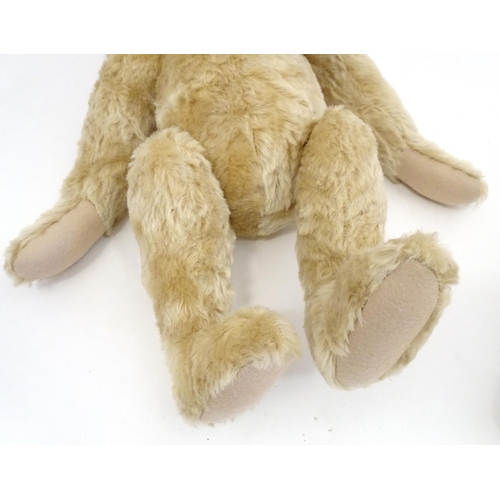 1324 - Toys: Three 20thC teddy bears with stitched noses, and articulated limbs and heads. The largest appr... 