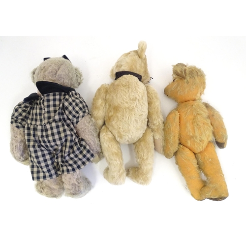 1324 - Toys: Three 20thC teddy bears with stitched noses, and articulated limbs and heads. The largest appr... 