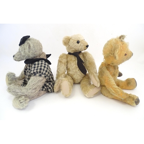 1324 - Toys: Three 20thC teddy bears with stitched noses, and articulated limbs and heads. The largest appr... 