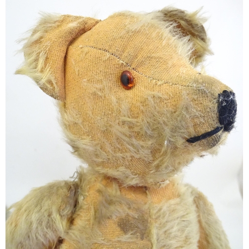 1324 - Toys: Three 20thC teddy bears with stitched noses, and articulated limbs and heads. The largest appr... 