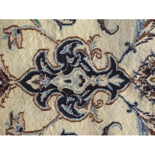 1374 - Carpet / Rug : A part silk Nain carpet, the cream ground with scrolling foliate detail and central m... 