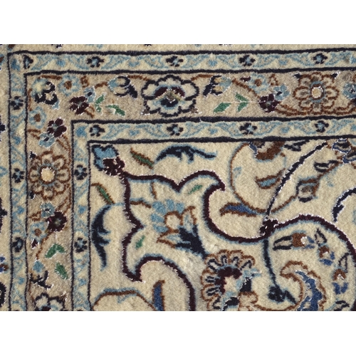 1374 - Carpet / Rug : A part silk Nain carpet, the cream ground with scrolling foliate detail and central m... 