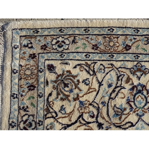 1374 - Carpet / Rug : A part silk Nain carpet, the cream ground with scrolling foliate detail and central m... 