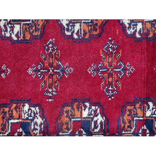 1375 - Carpet / Rug : A Turkoman rug, the red ground with bands of medallions and vignettes Approx. 70 1/2