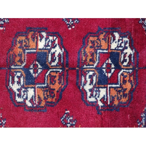 1375 - Carpet / Rug : A Turkoman rug, the red ground with bands of medallions and vignettes Approx. 70 1/2