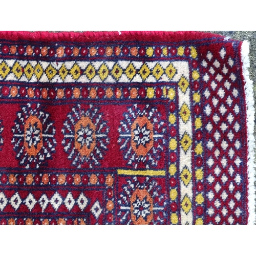 1375 - Carpet / Rug : A Turkoman rug, the red ground with bands of medallions and vignettes Approx. 70 1/2