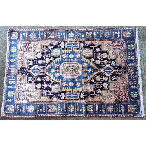 1376 - Carpet / Rug : A Nahawand rug, stylised floral motifs and geometric symbols on a ground of blue, cre... 