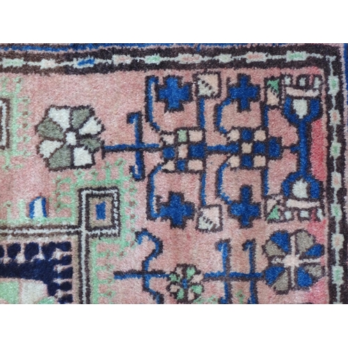 1376 - Carpet / Rug : A Nahawand rug, stylised floral motifs and geometric symbols on a ground of blue, cre... 